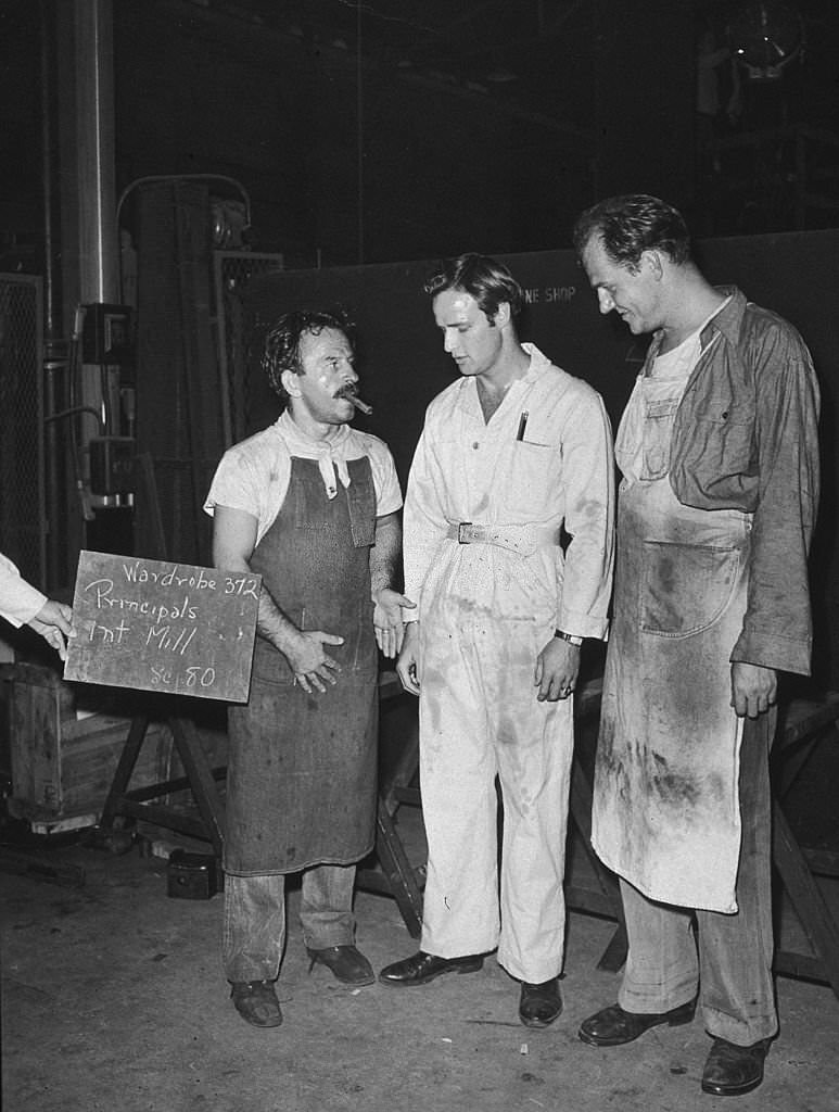 Greek actor Nick Dennis talks with Marlon Brando and Karl Malden during a wardrobe test for the film, 'A Streetcar Named Desire,.