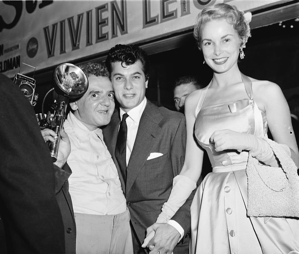 Photographer Arthur 'Weegee' Fellig with American film star couple Tony Curtis and Janet Leigh after a showing of 'A Streetcar Named Desire'.