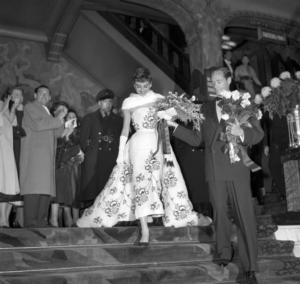 Audrey Hepburn accompanied by her husband actor Mel Ferrer, in Amsterdam.