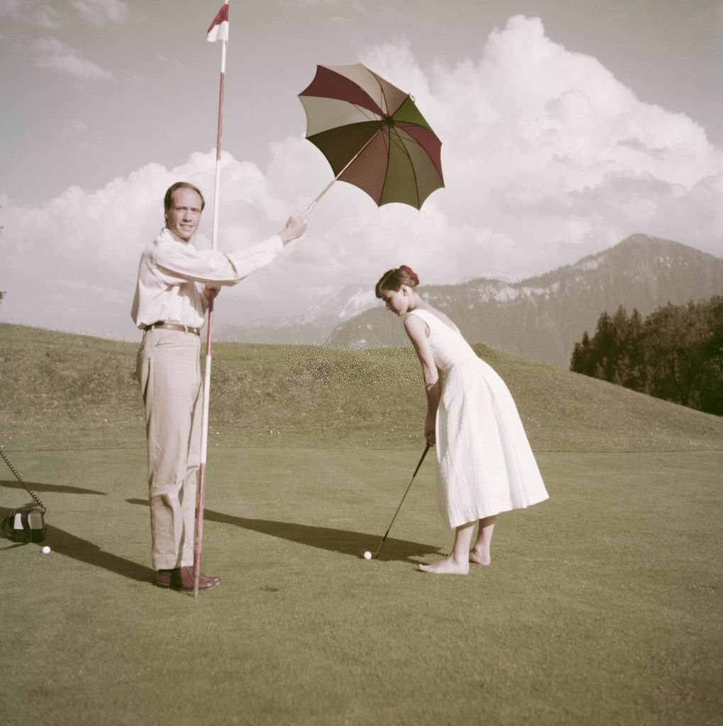 Audrey Hepburn and Mel Ferrer on a golf course at the Bürgenstock resort, Switzerland, 1954.