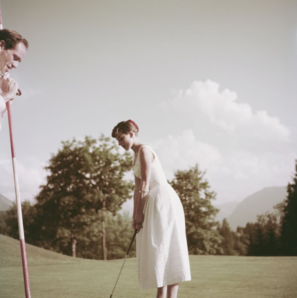 Audrey Hepburn and Mel Ferrer on a golf course at the Bürgenstock resort, Switzerland, 1954.