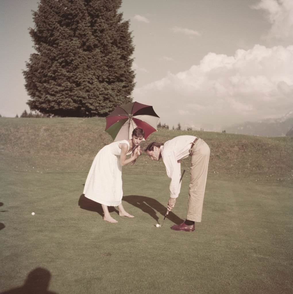 Audrey Hepburn and Mel Ferrer on a golf course at the Bürgenstock resort, Switzerland, 1954.