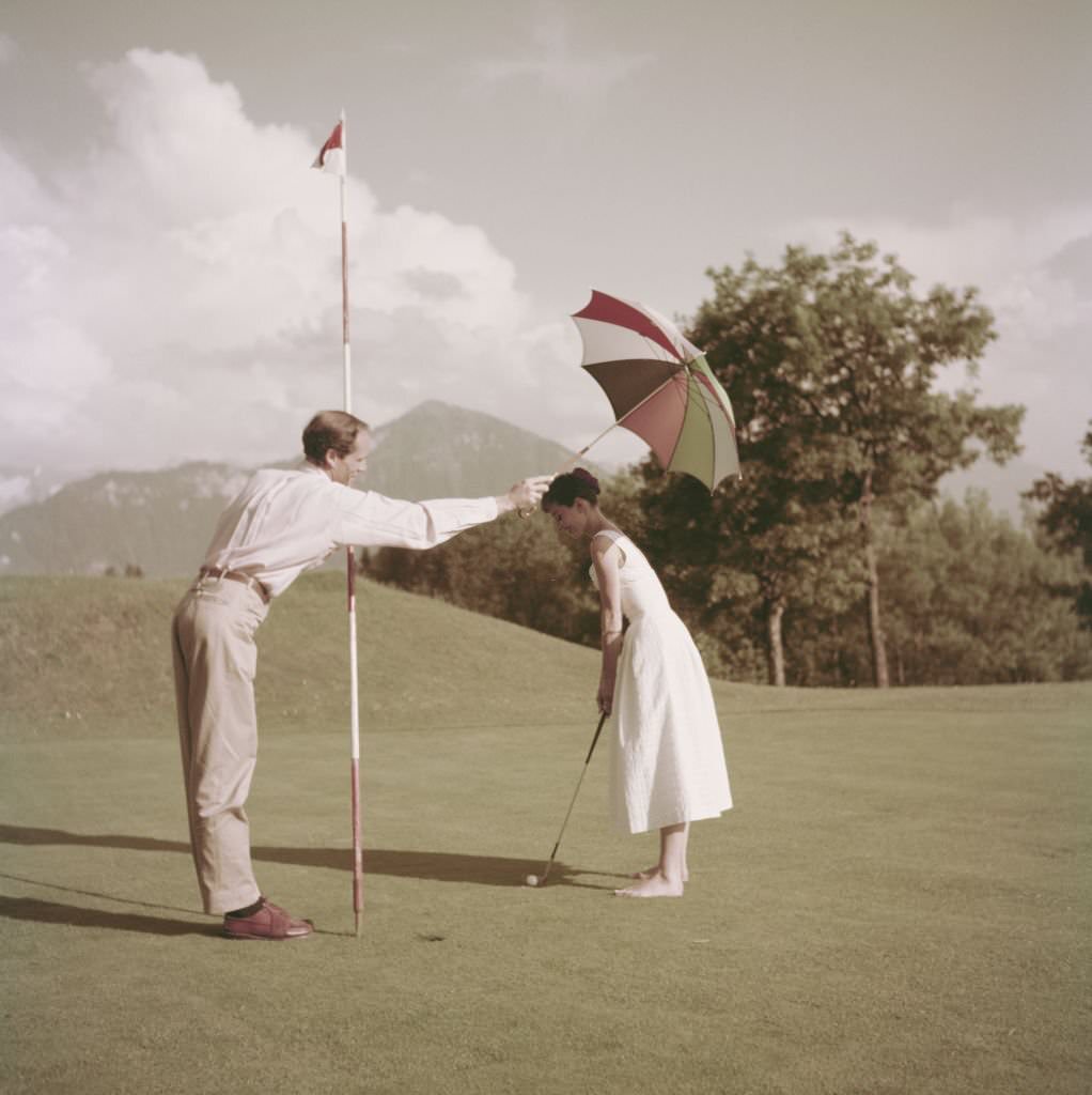Hepburn and Ferrer Playing Golf.