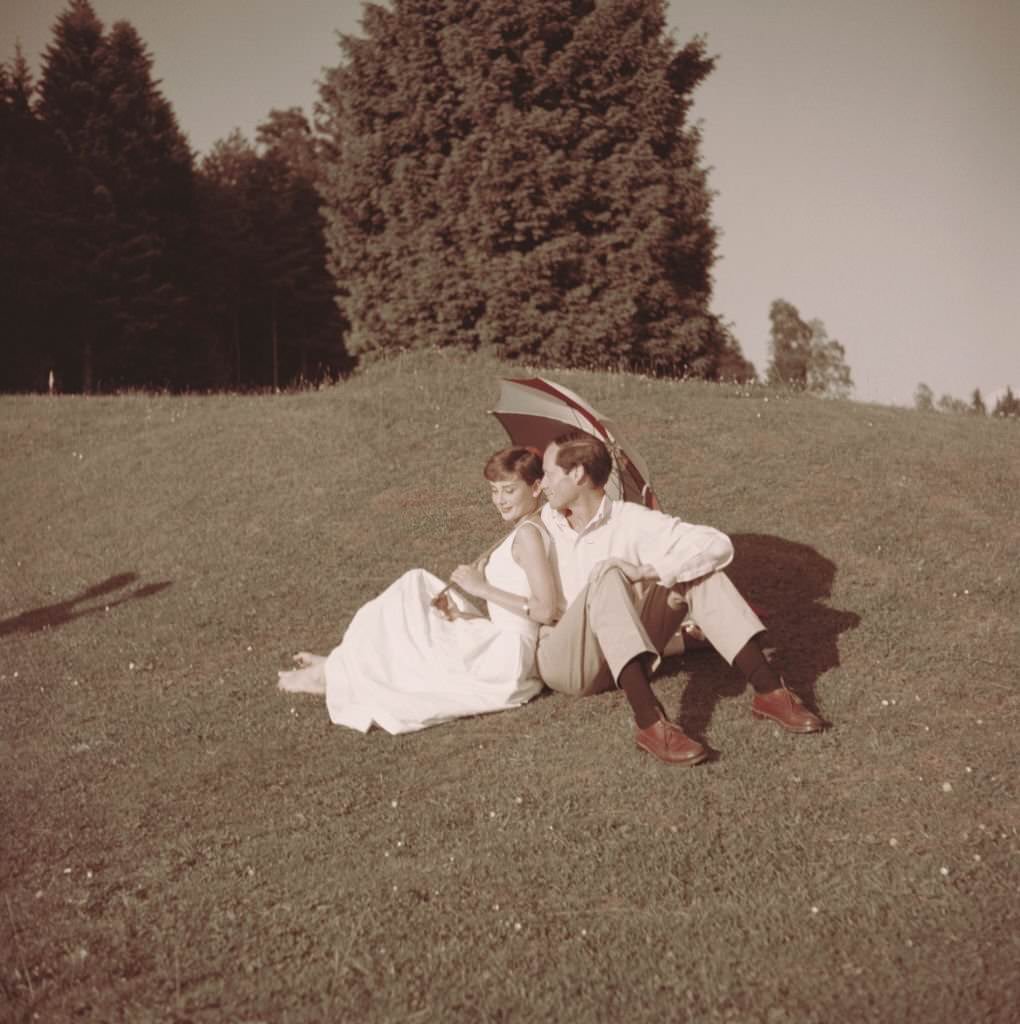 Audrey Hepburn with her husband Mel Ferrer on a golf course at the Bürgenstock resort, Switzerland, 1954.