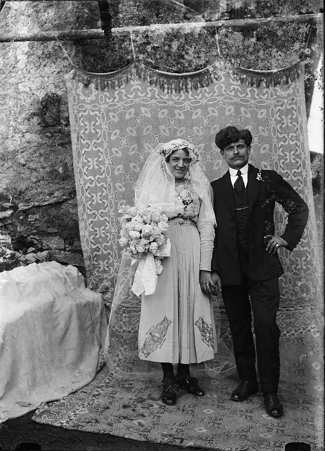 A wedding couple staged in front of a cloth