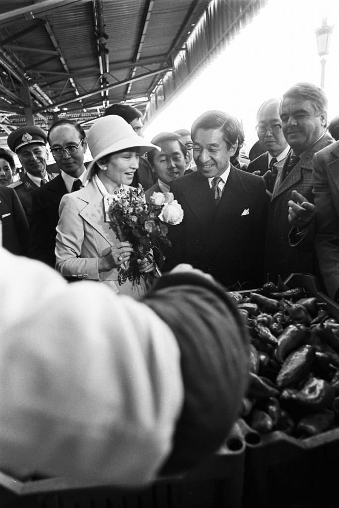 Crown Prince Akihito and Crown Princess Michiko visit a market on October 10, 1979 in Bucharest.