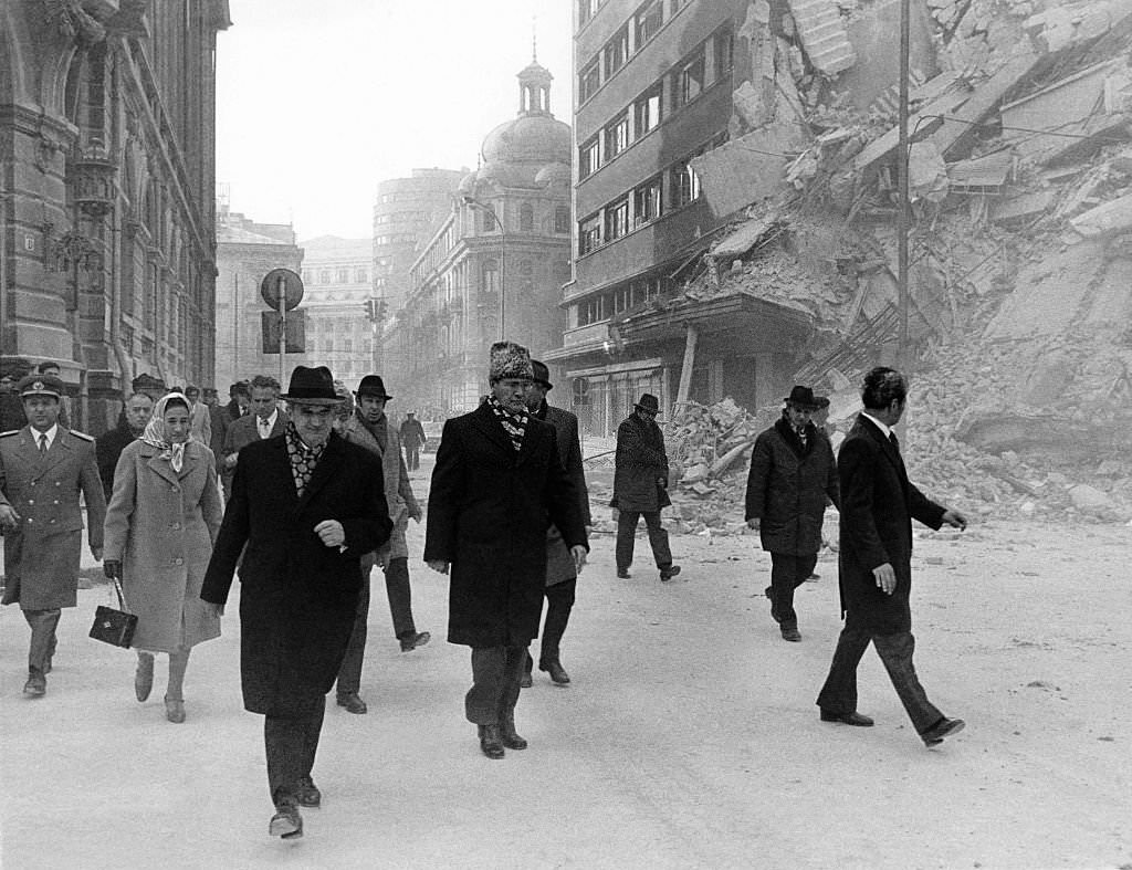 Romanian president Nicolae Ceausescu observing the damages on the Gheorghe Magheru Boulevard in Bucharest after an earthquake.