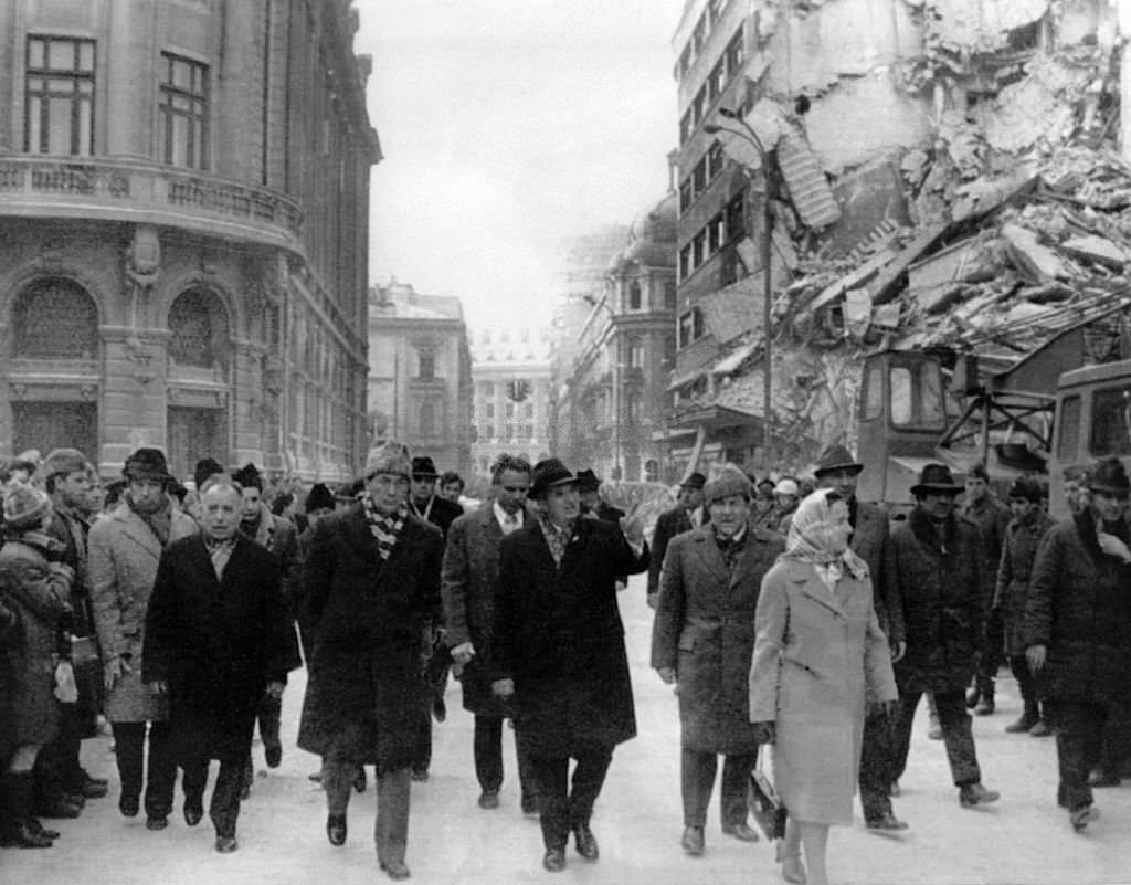 Romanian president Nicolae Ceausescu observing the damages on the Gheorghe Magheru Boulevard in Bucharest after an earthquake.