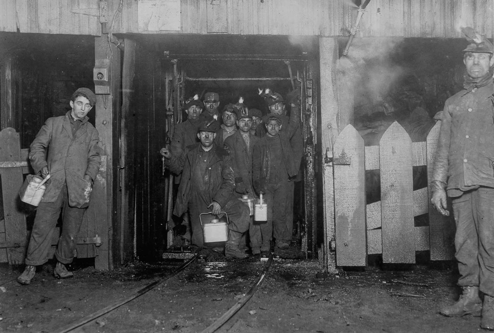 Workers wait for the cage to ascend to the surface at the end of the day, 1910