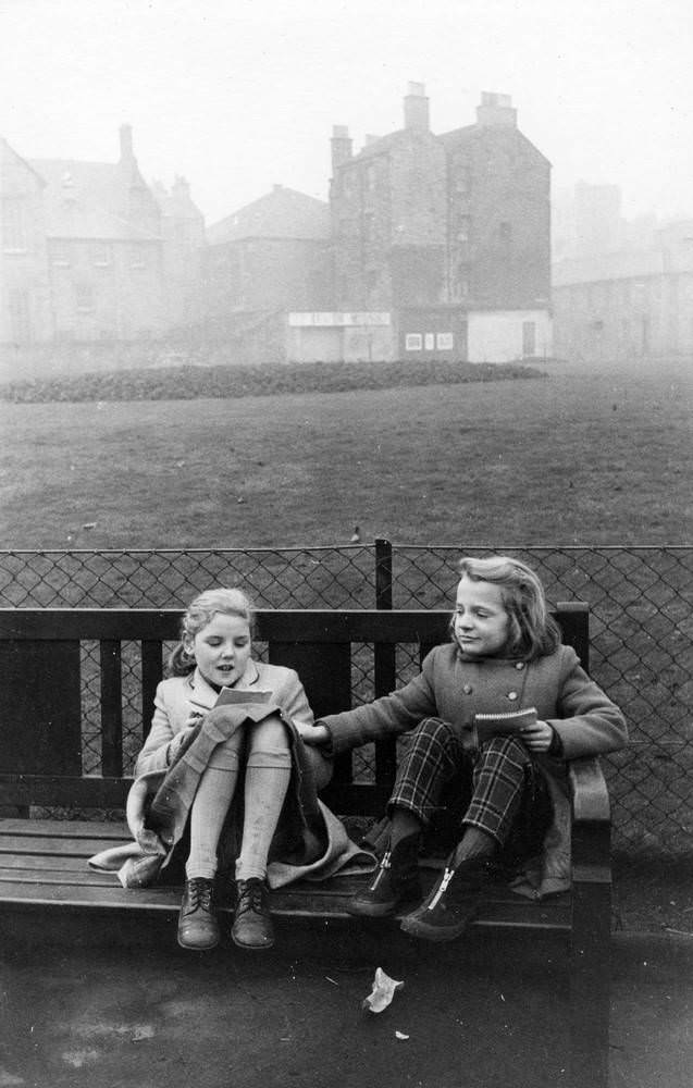 Girls sitting on the bench in foggy evening, West Richmond Street, Edinburgh, 1960