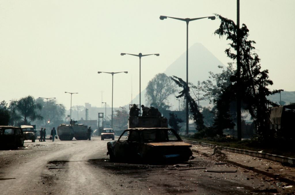 A burned out car lies on the road after the protest and police riot in Cairo on February 26, 1986.