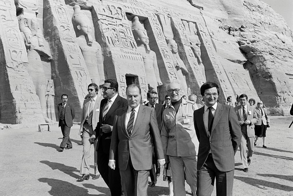 French President Francois Mitterrand (C) and his advisor Jacques Attali (R), flanked with their interpreter (2nd R), visit on November 26, 1982 the Abu Simbel temples during an official visit to Egypt.