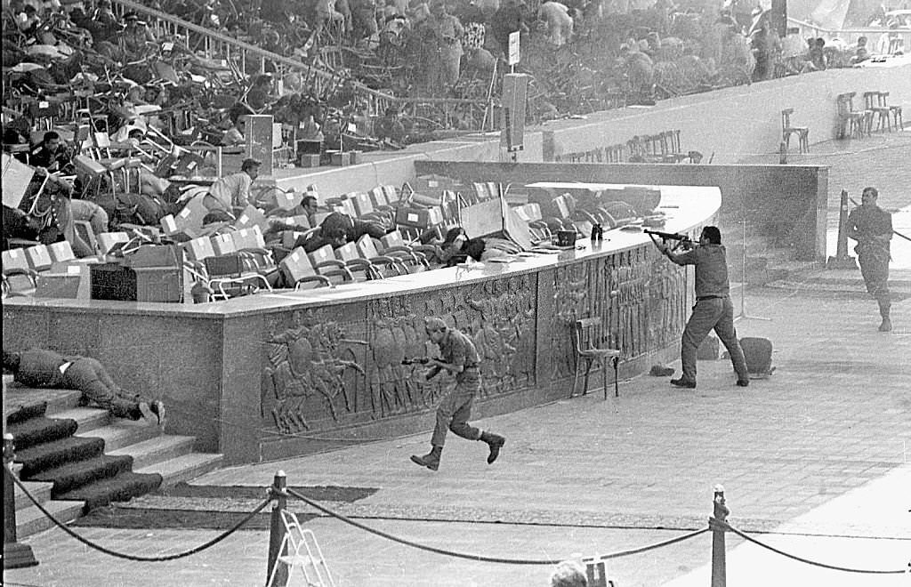 Egyptian soldiers fire on Egyptian President Anwar Al-Sadat while reviewing a military parade in honor.