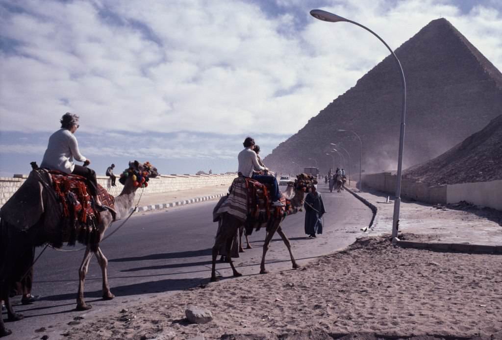 Tourist on the back of a dromedary in front of a pyramid in Egypt, 1981
