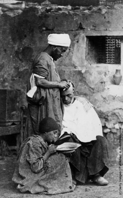 A barber at work in Cairo, 1880