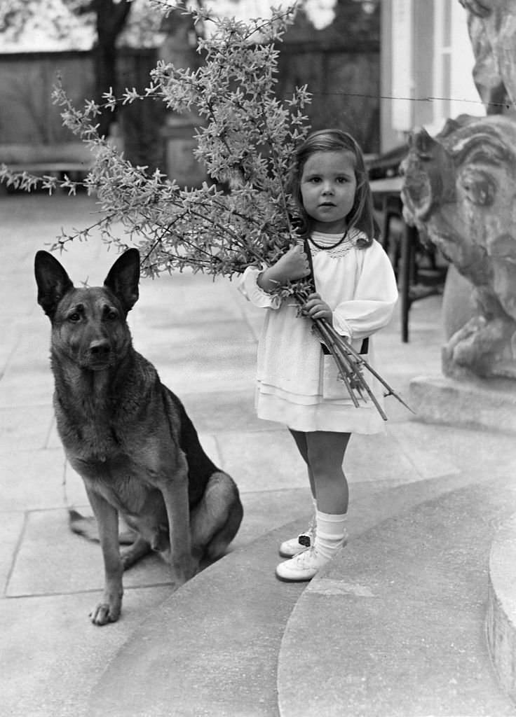 with her daughter Helga with a bouquet of forsythia, 1937