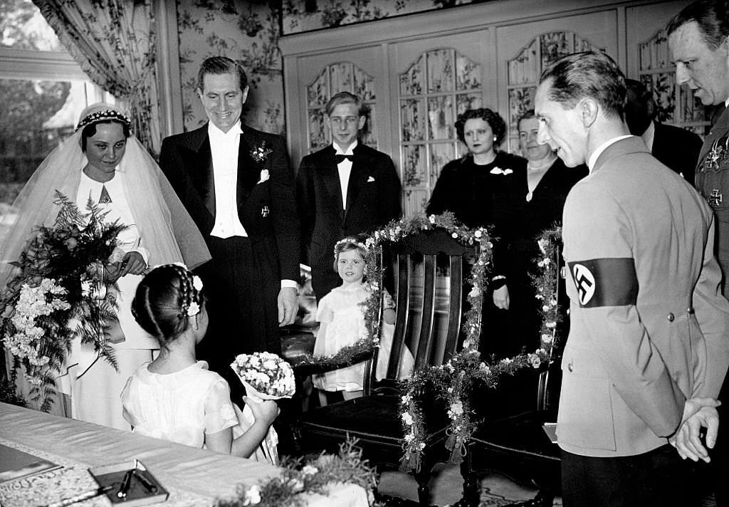 Joseph Goebbels on the occasion of his sisters marriage, his sister Maria and her husband, film director Max Kimmich, getting flowers from Goebbels' daughter Helga, 1938