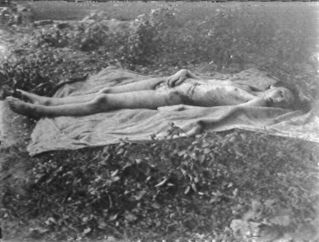 The body of Helga Goebbels lies on a blanket in a field after Russian troops moved her and her siblings' bodies from the beds in the bunker where their parents poisoned them, Berlin, May 1945