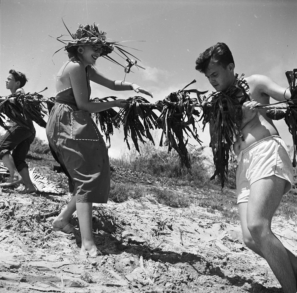 Visitors to Hawaii join in the 'Hukilau', 1955
