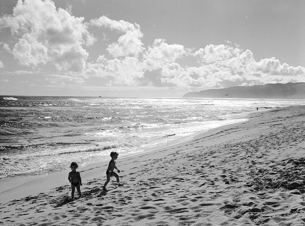 The white sands and warm Pacific waters of a Hawaiian beach, 1955