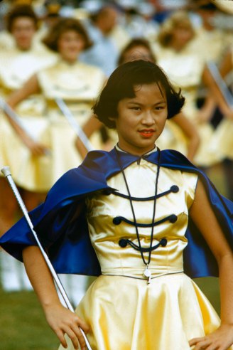 Drum majorette leads band at Honolulu football game, 1959