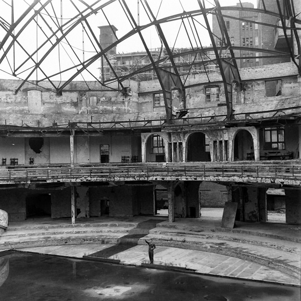 An American soldier, PFC Douglas Page, offers a mocking Nazi salute inside the bombed-out ruins of the Berliner Sportspalast, or Sport Palace.