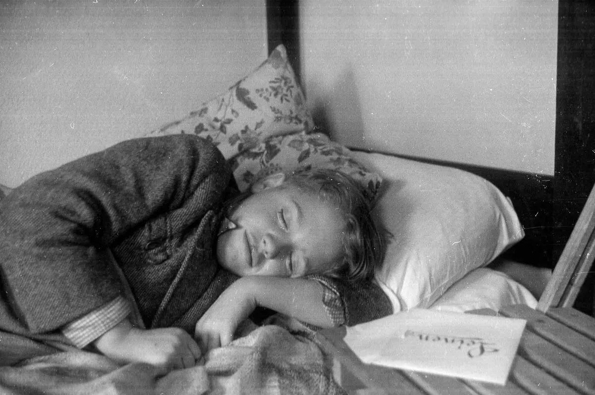 A refugee takes a much-deserved rest after arriving at the Dovercourt holiday camp, December 17, 1938.