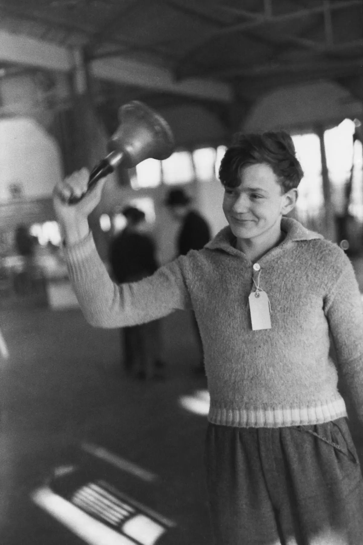 A refugee rings the dinner bell at the Dovercourt holiday camp, 1938.