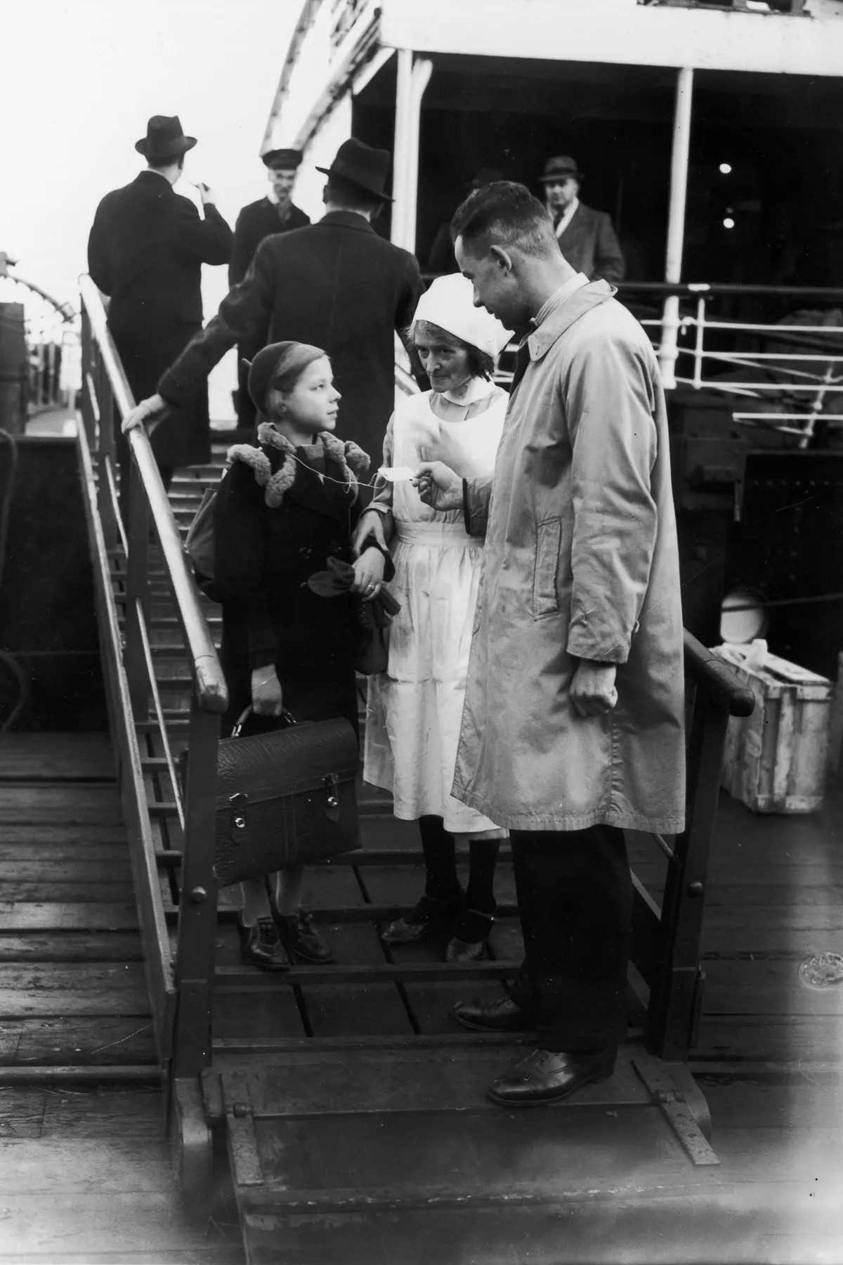 German-Jewish girl Helga Samuel is met by a Kindertransport agent upon arriving in Harwich. December 2, 1938.