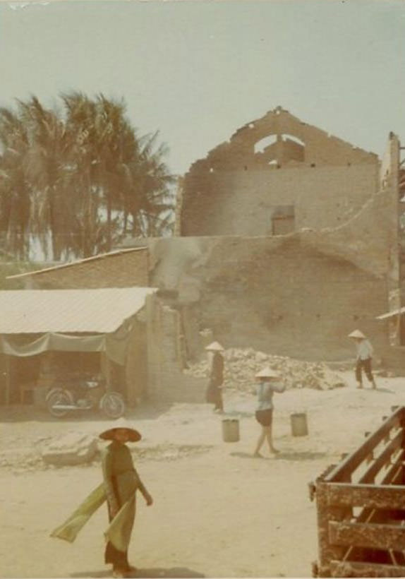 Fallen walls and roof on a large building, caused by bomb-damage, believed to be in the city of Huế, Vietnam, during the Vietnam War