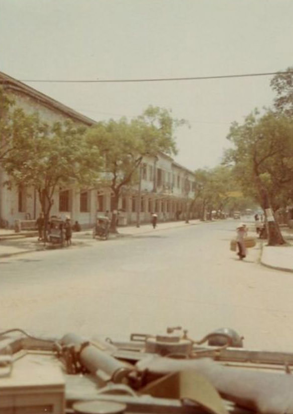 Looking down a road believed to be in the city of Huế, Vietnam, during the Vietnam War.