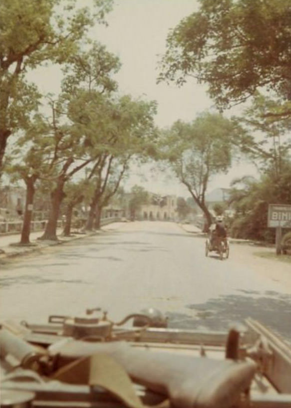 Looking down a road believed to be in the city of Huế, Vietnam, during the Vietnam War