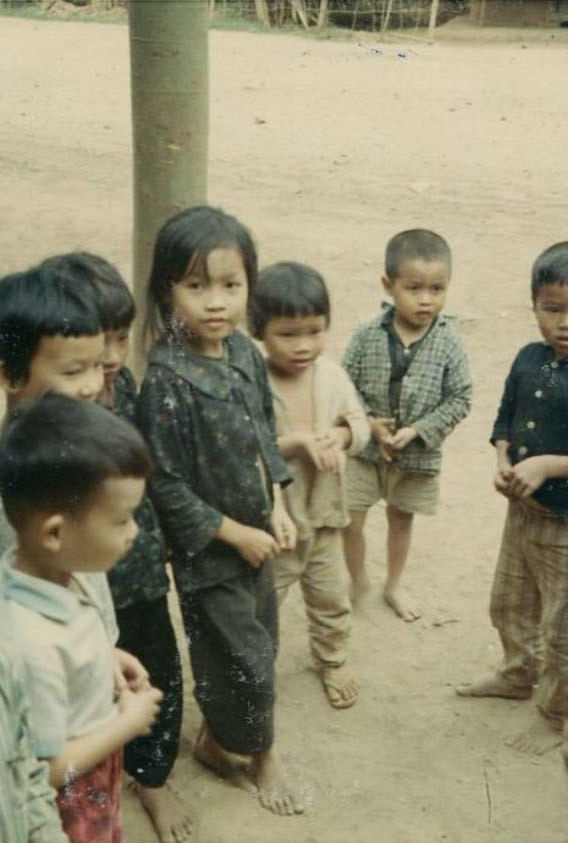A group of Vietnamese children outside in an unidentified village in South Vietnam.