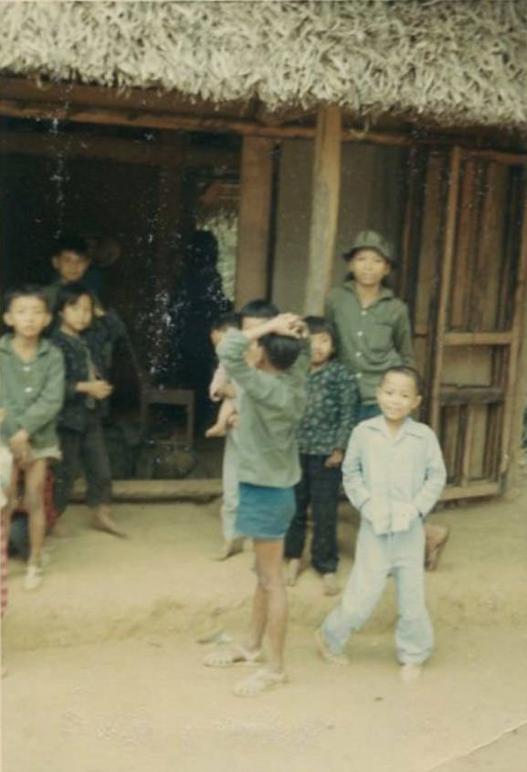 Vietnamese children outside of a hut in an unidentified village in South Vietnam during the Vietnam War