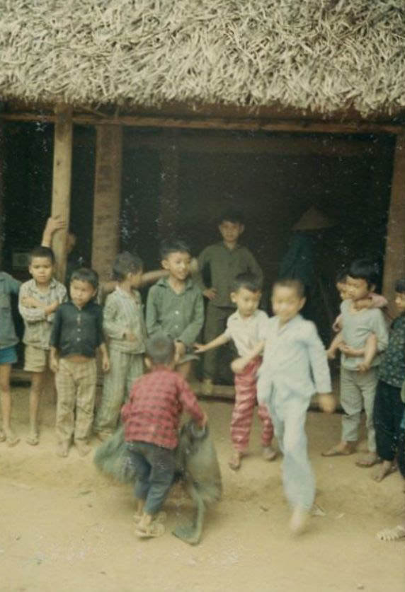 A group of Vietnamese children outside of a hut in an unidentified village in South Vietnam.