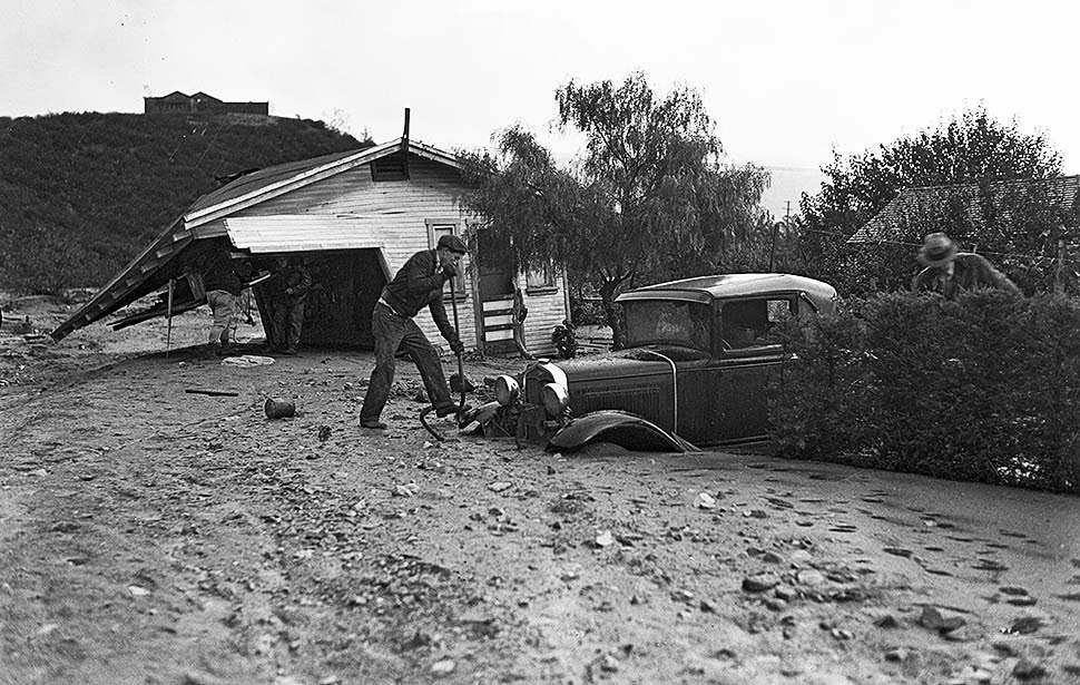 Workers dig out a car and remains of a home on Glenada Avenue in Montrose following flooding from a storm the night before, 1934