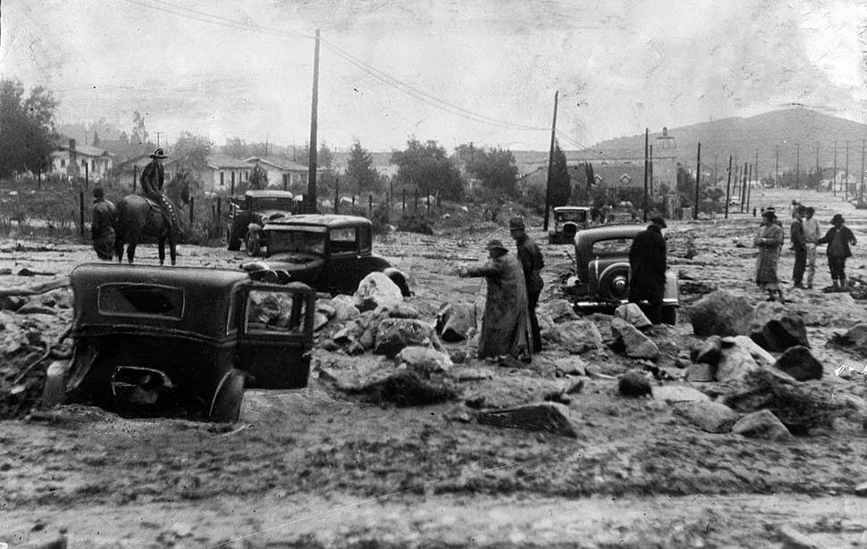 Mud, rocks and damaged cars on Montrose Avenue in Montrose after New Year's flooding, 1934