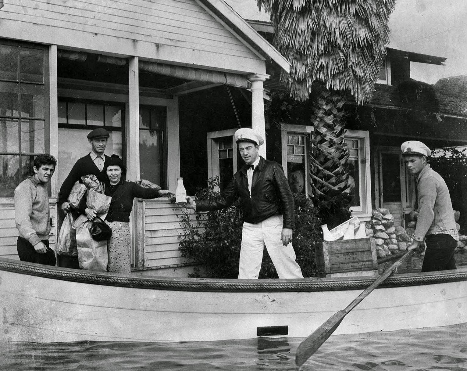 Milkman Ray J. Henville secured himself a boat and boatman and made all deliveries on time and on doorstep, 1938