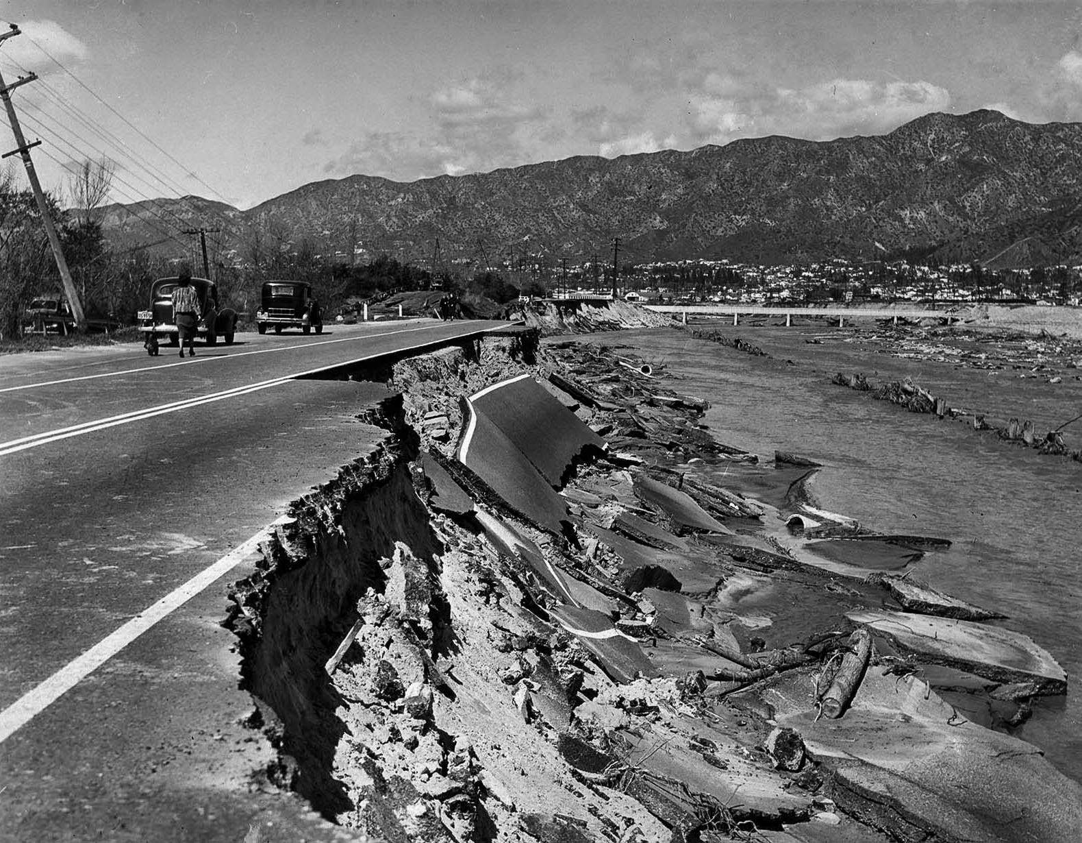 Heavily traveled Riverside Drive in Glendale was undermined by the torrent of the Los Angeles River. This damaged section was near the former Grand Central Airport, 1938