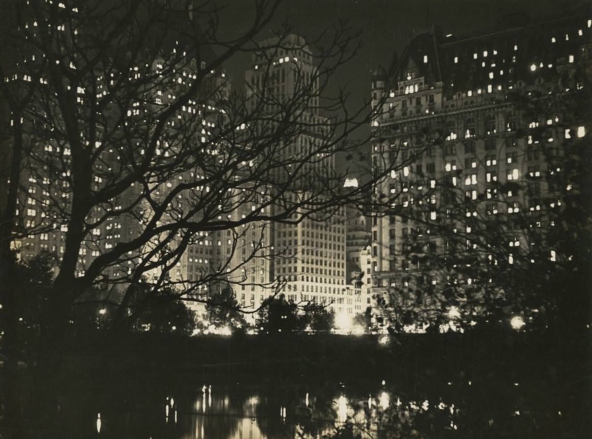 Central Park South at night on Fifth Avenue and 59th Street.