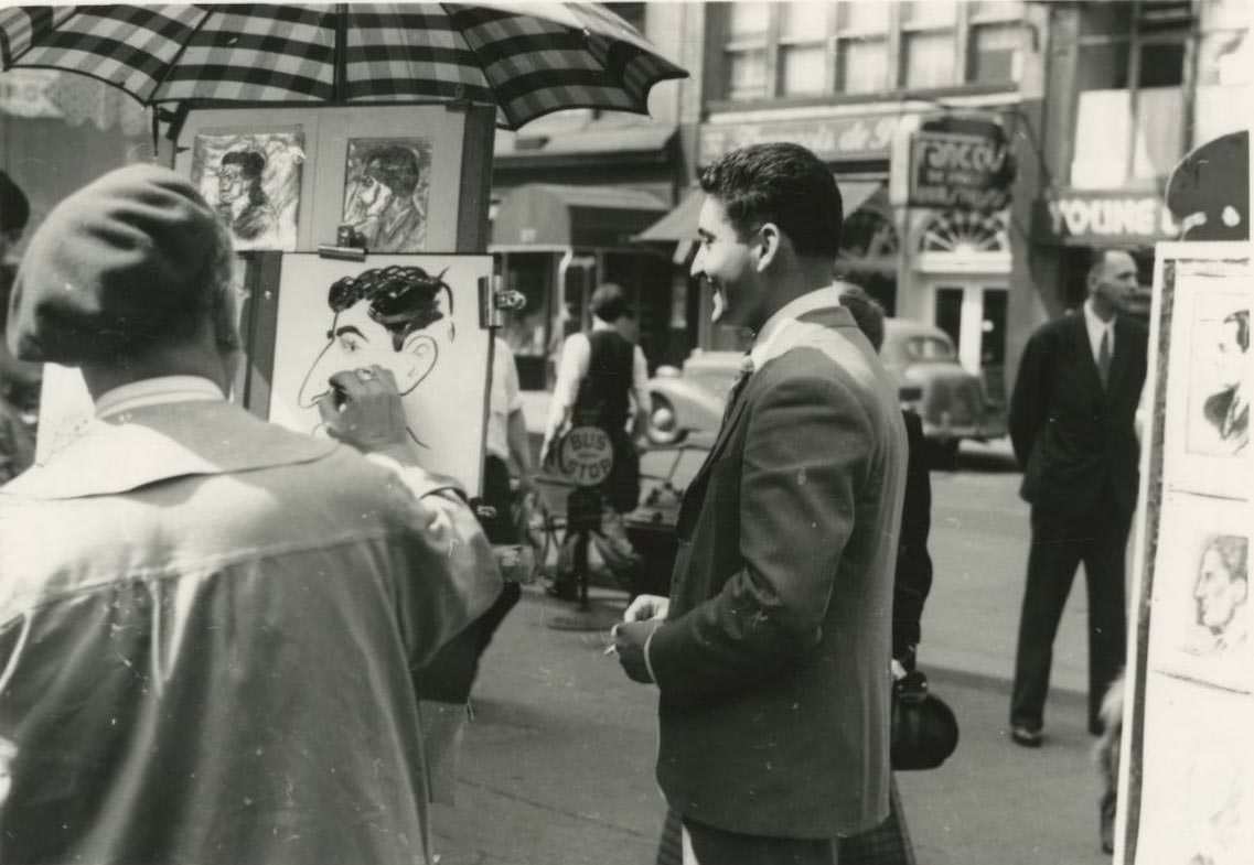 A street artist draws a caricature of a man in Greenwich Village.