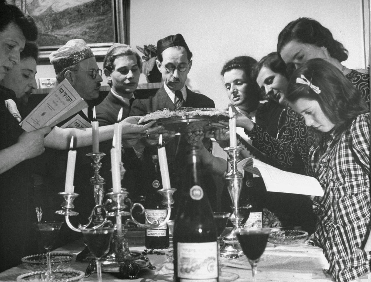 Tasting bitter herbs, symbolizing hardships of ancient Jews in Egyptian slavery, during the Passover seder.