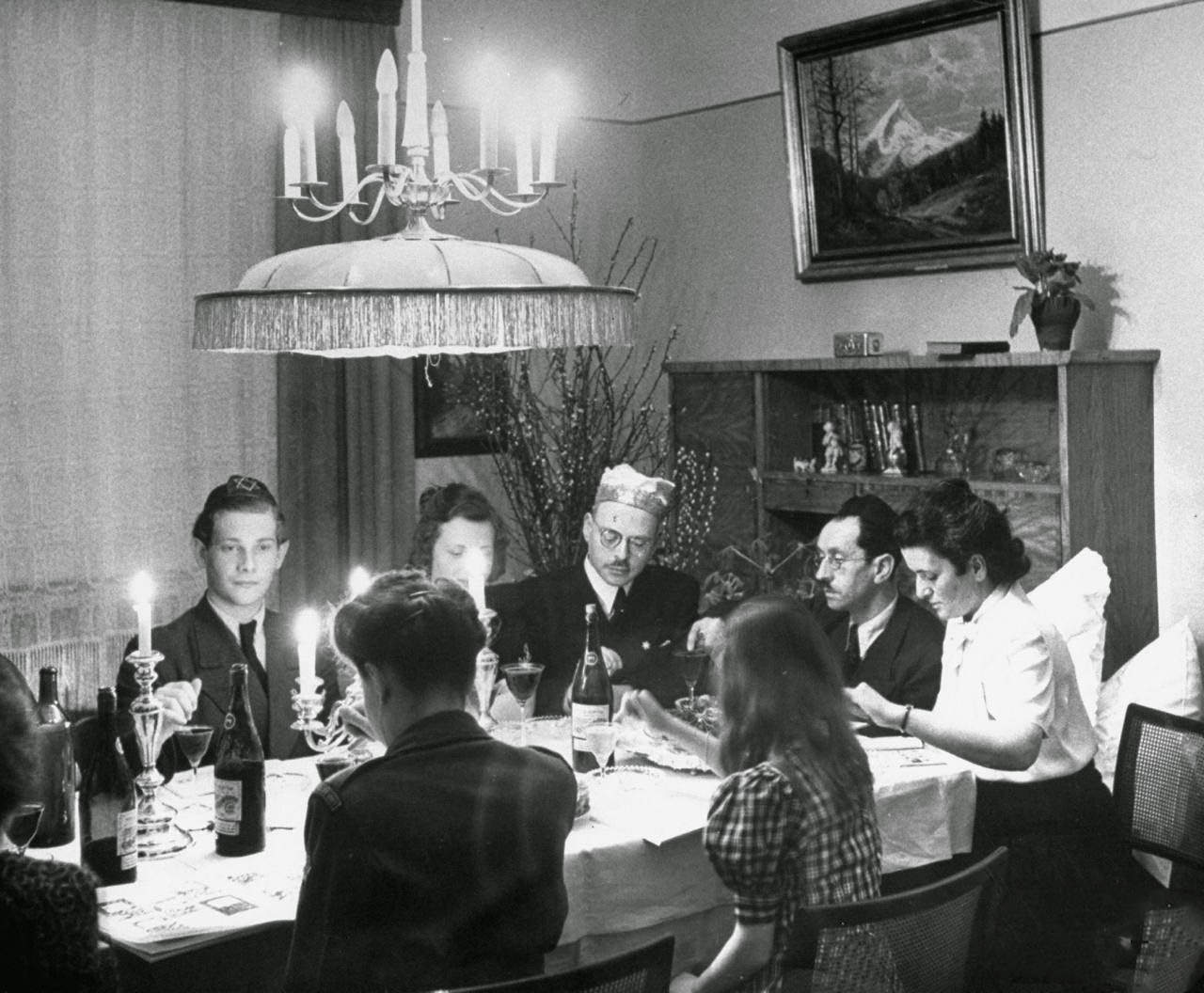 A family and their guests having Passover Eve seder.