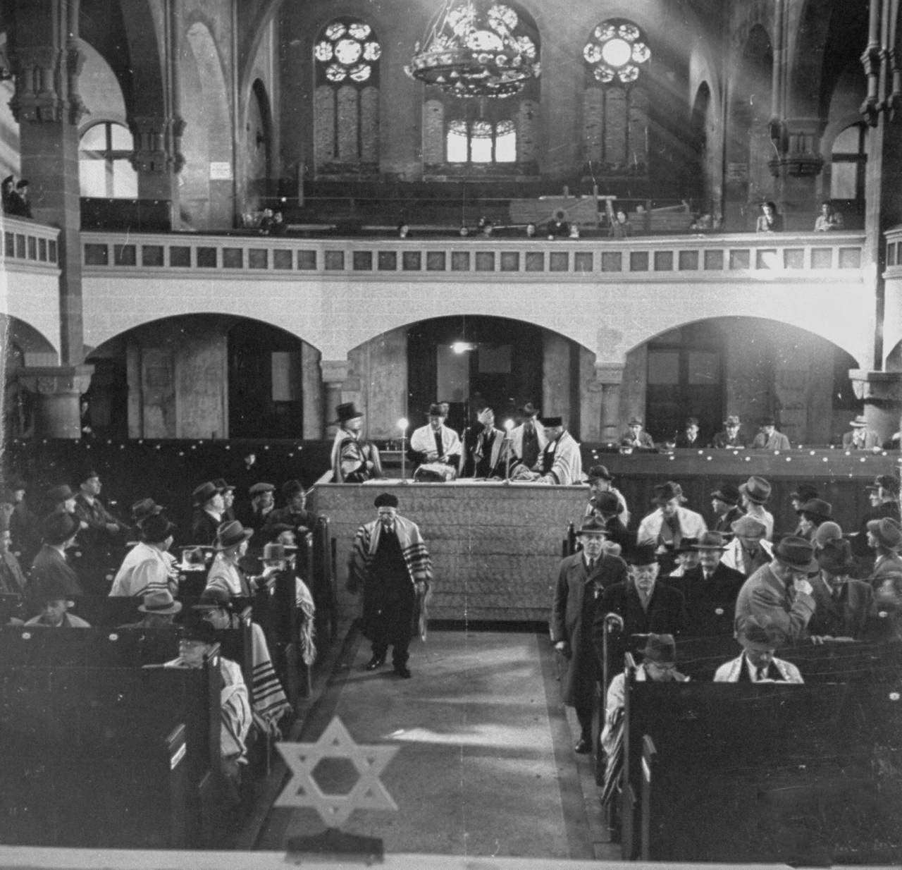 Torah scrolls being read to the congregation in the synagogue during Passover.