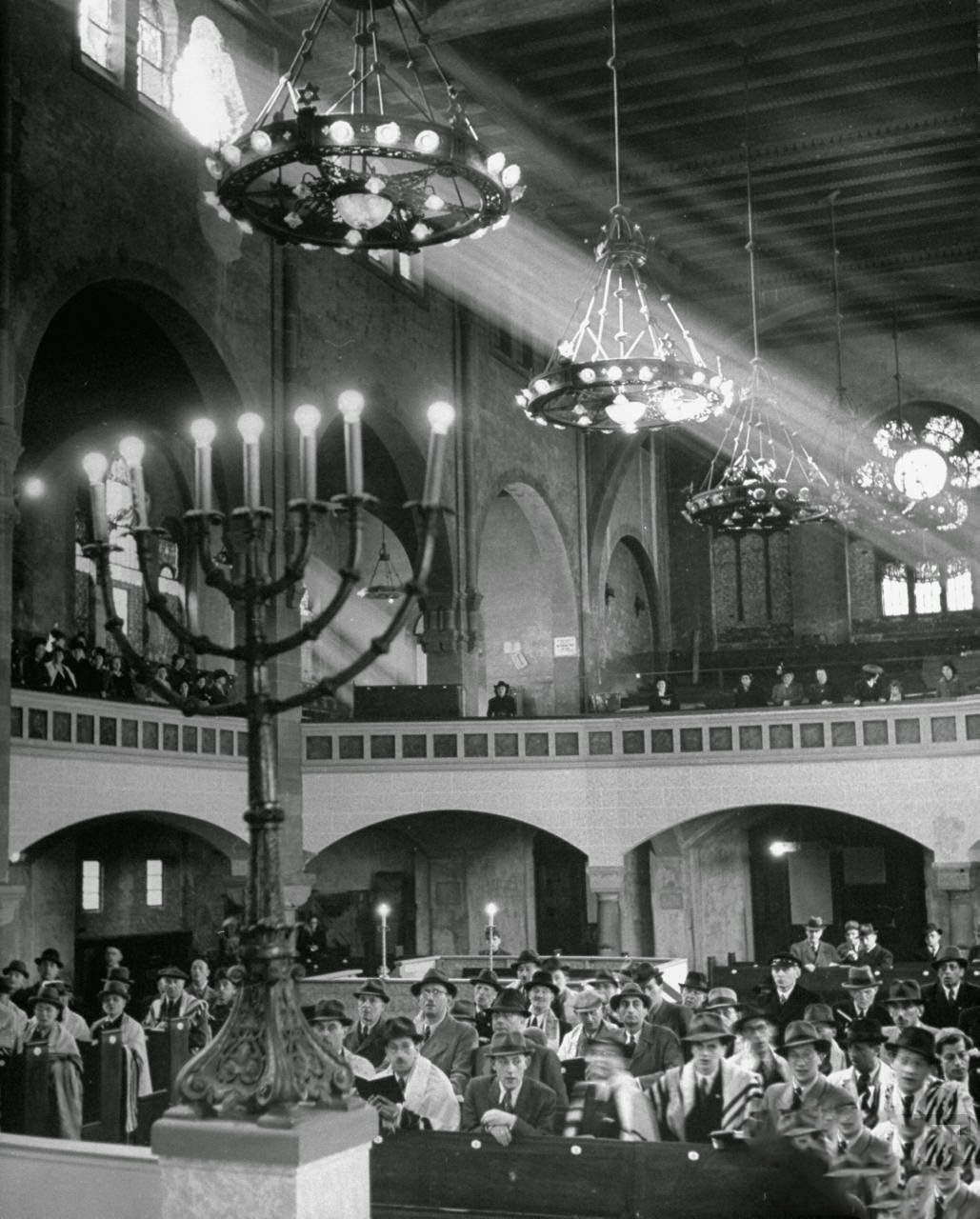 Jewish congregation observing synagouge services during Passover.