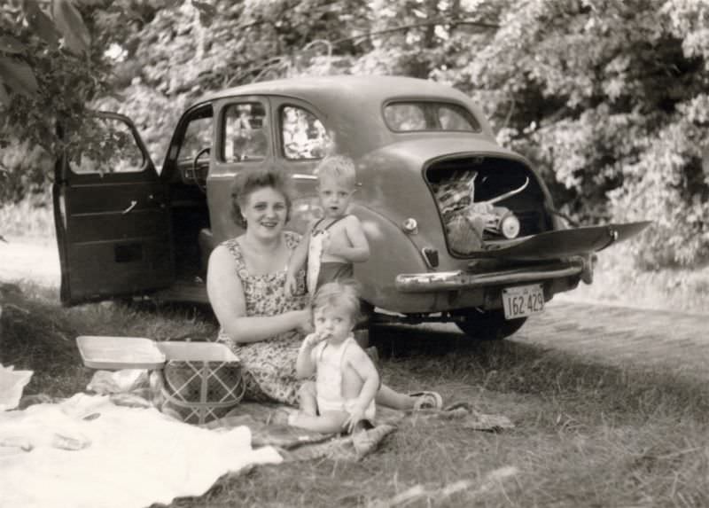 A mother and her children enjoying a picnic in the countryside, 1955