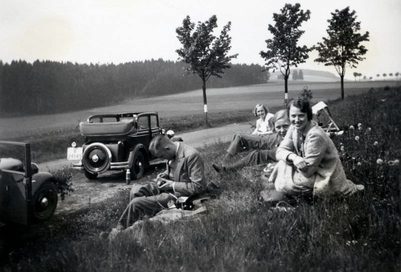 A company of seven (including the photographer) enjoying a picnic in the countryside, 1936