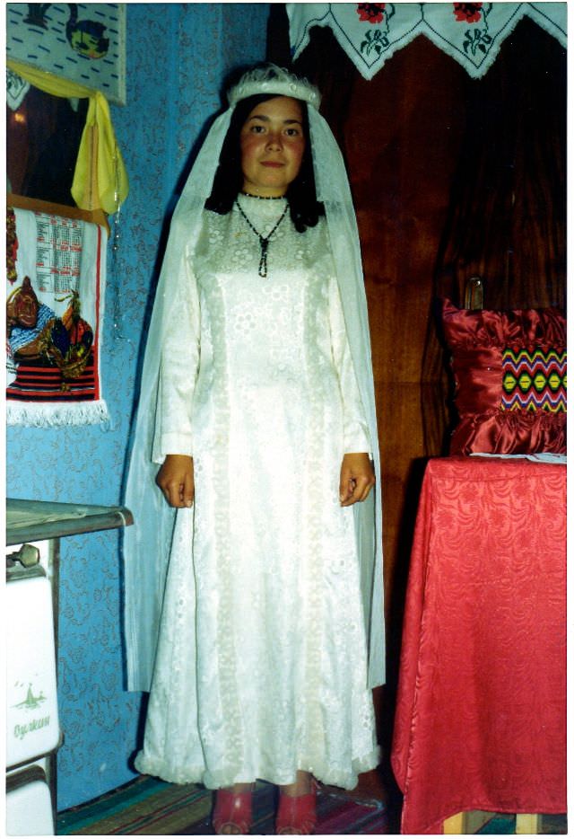 Gülizar trying on a wedding gown, Polyanovo, Bulgaria, 1976