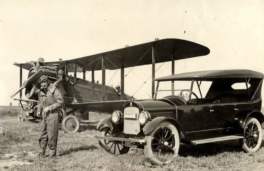 Eddie Rickenbacker with biplane and automobile, 1925