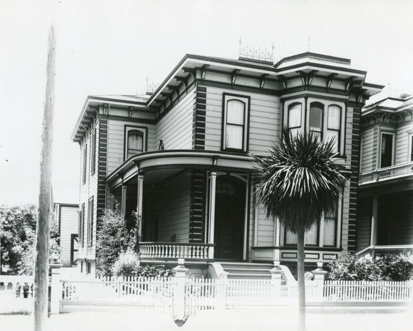 Two-story Victorian house, palm tree, 1970s